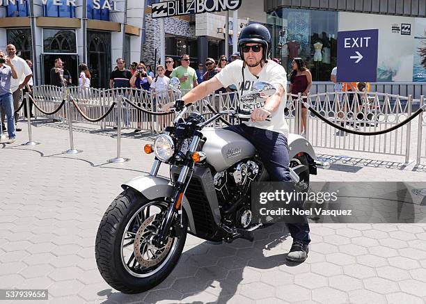 Mark Wahlberg rides a motorcycle at "Extra" at Universal Studios Hollywood on June 3, 2016 in Universal City, California.