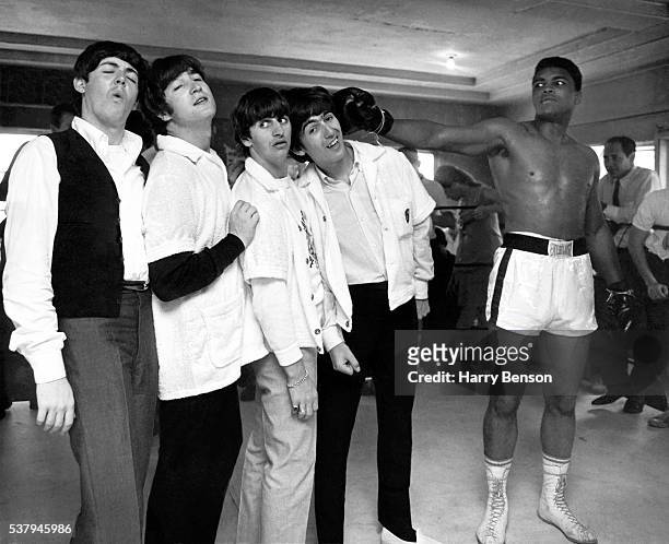 Former heavyweight champion Cassius Clay and the Beatles are photographed at the 5th Street Gym in 1964 in Miami, Florida.