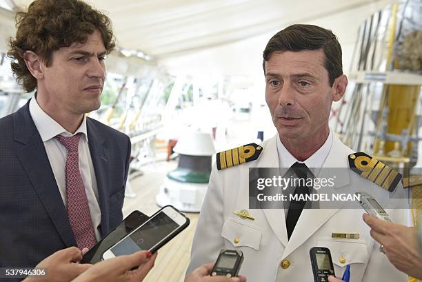 Argentina's Ambassador to the US Martin Lousteau watches as Libertad Commander, Captain Ignacio Martin Errecaborde, speaks to reporters onboard...