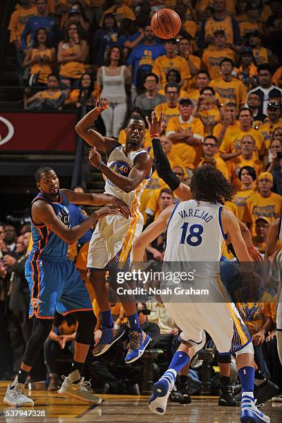 Harrison Barnes of the Golden State Warriors passes the ball to Anderson Varejao of the Golden State Warriors during the game against Kevin Durant of...