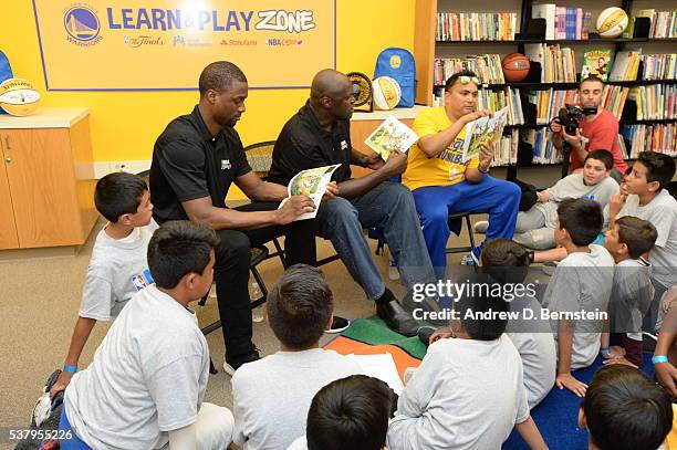 Harrison Barnes of the Golden State Warriors and former player Adonal Foyle read a book to the children at the 2016 NBA Finals Cares Legacy project...