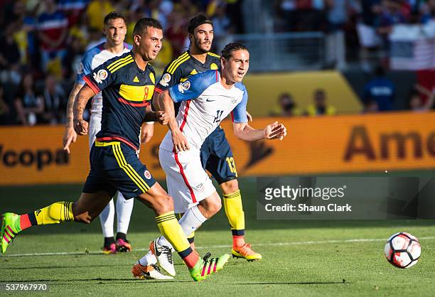 Alejandro Bedoya of United States looks upfield as Edwin Cardona of Colombia closes him down during the Copa America Centenario Group A match between...