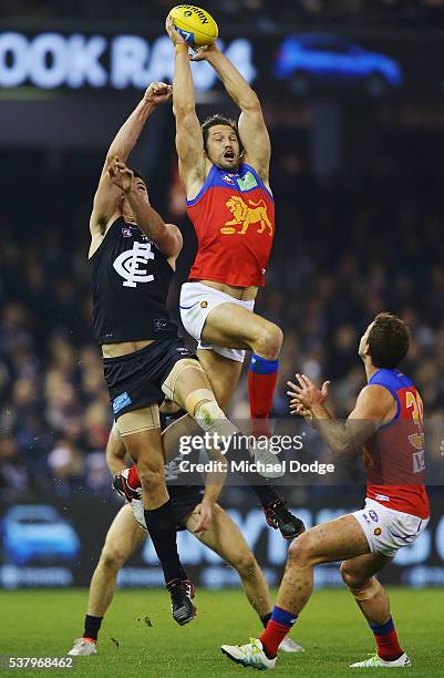 Stefan Martin of the Lions marks the ball against Matthew Kreuzer of the Blues during the round 11 AFL match between the Carlton Blues and the...