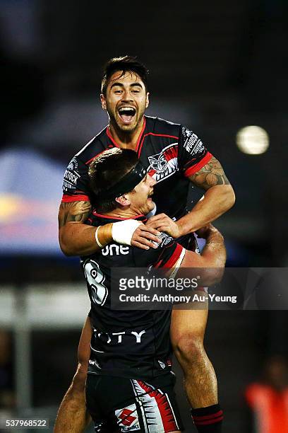 Shaun Johnson of the Warriors celebrates his teammate Jacob Lillyman's try during the round 13 NRL match between the New Zealand Warriors and the...