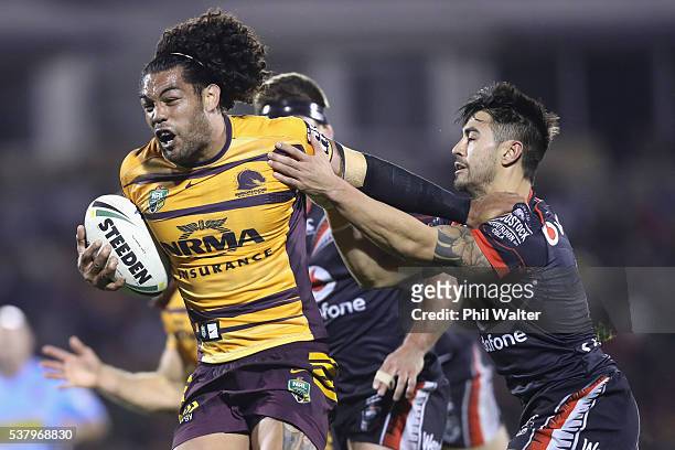 Adam Blair of the Broncos is tackled by Shaun Johnson of the Warriors during the round 13 NRL match between the New Zealand Warriors and the Brisbane...