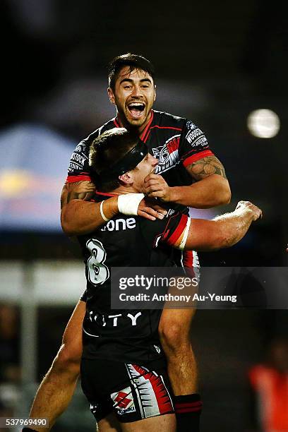 Shaun Johnson of the Warriors celebrates his teammate Jacob Lillyman's try during the round 13 NRL match between the New Zealand Warriors and the...