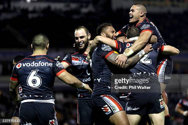 Tuimoala Lolohea and Manu Vatuvei celebrate a try to Ryan Hoffman of the Warriors during the round 13 NRL match between the New Zealand Warriors and...