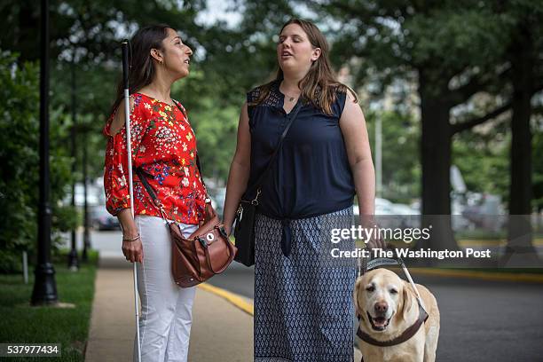 Tiffany Jolliff, talks with lawyer Deepa Goraya, from the the Washington Lawyers Committee for Civil Rights and Urban Affairs, after they filed a...