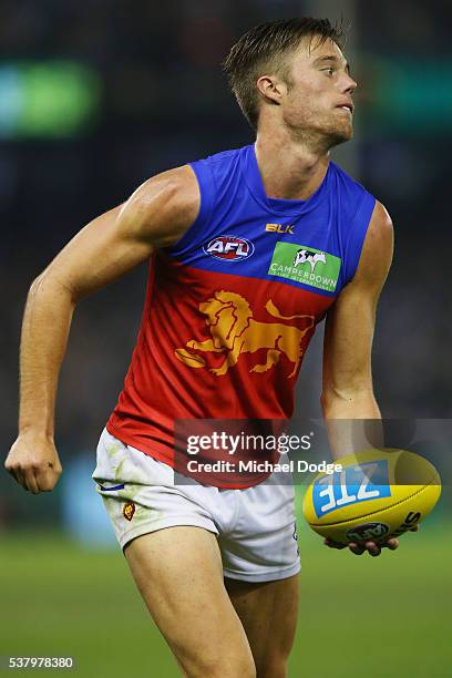 Josh Schache of the Lions handballs during the round 11 AFL match between the Carlton Blues and the Brisbane Lions at Etihad Stadium on June 4, 2016...