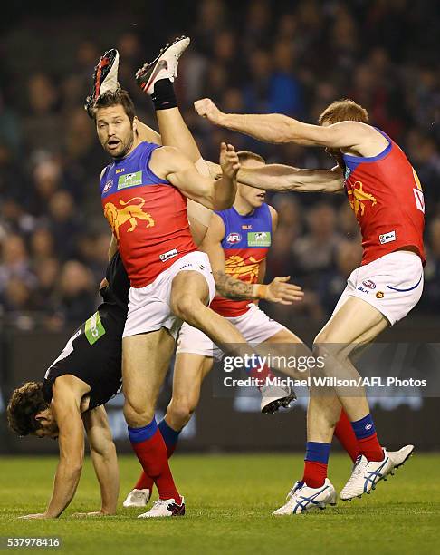 Levi Casboult of the Blues attempts a spectacular mark over Daniel Merrett of the Lions during the 2016 AFL Round 11 match between the Carlton Blues...