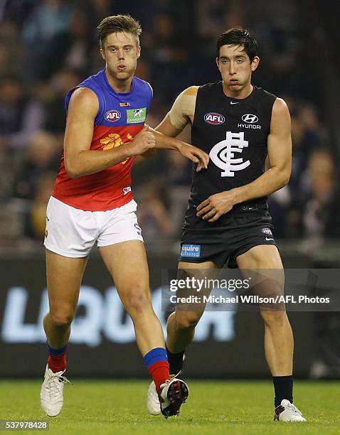 Josh Schache of the Lions and Jacob Weitering of the Blues look on during the 2016 AFL Round 11 match between the Carlton Blues and the Brisbane...