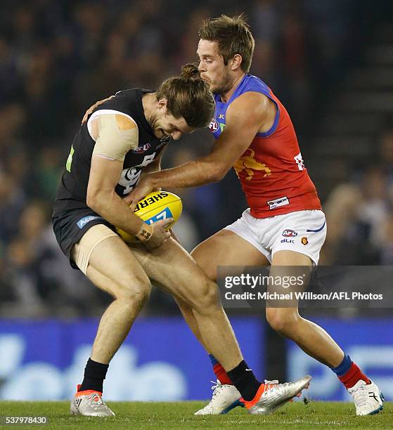 Ryan Bastinac of the Lions tackles Bryce Gibbs of the Blues during the 2016 AFL Round 11 match between the Carlton Blues and the Brisbane Lions at...