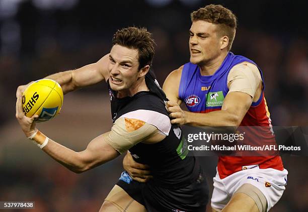 Jed Lamb of the Blues is tackled by Tom Cutler of the Lions during the 2016 AFL Round 11 match between the Carlton Blues and the Brisbane Lions at...