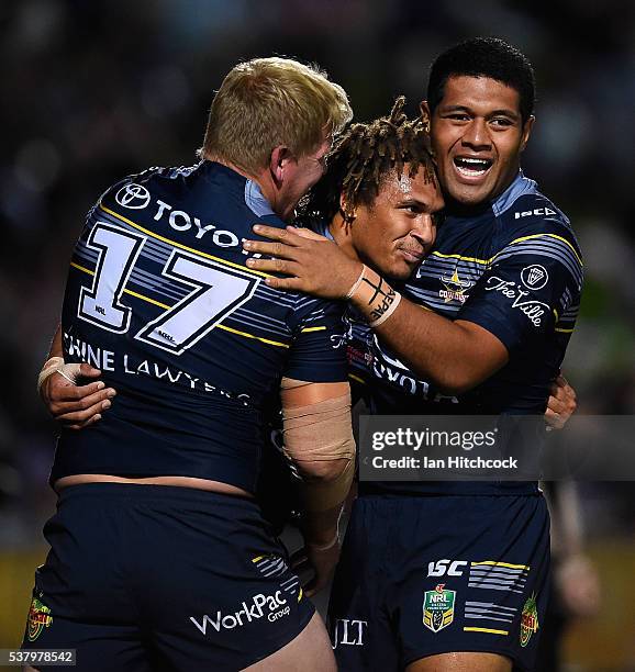 Ray Thompson of the Cowboys celebrates after scoring a try with Ben Hannant and John Asiata of the Cowboys during the round 13 NRL match between the...