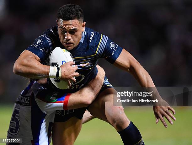 Antonio Winterstein of the Cowboys is tackled by Jake Mamo of the Knights during the round 13 NRL match between the North Queensland Cowboys and the...