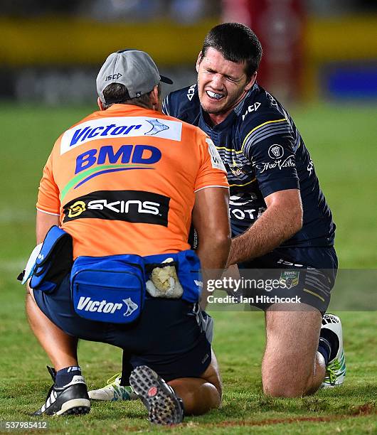 Lachlan Coote of the Cowboys grimaces with pain after being injured during the round 13 NRL match between the North Queensland Cowboys and the...