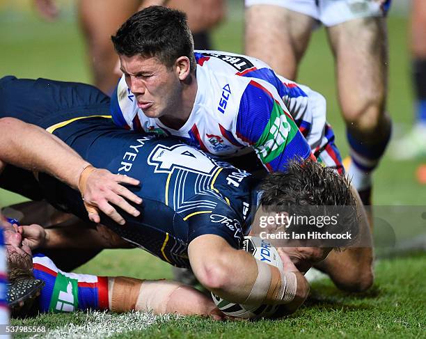 Rory Kostjasyn of the Cowboys scores a try during the round 13 NRL match between the North Queensland Cowboys and the Newcastle Knights at 1300SMILES...