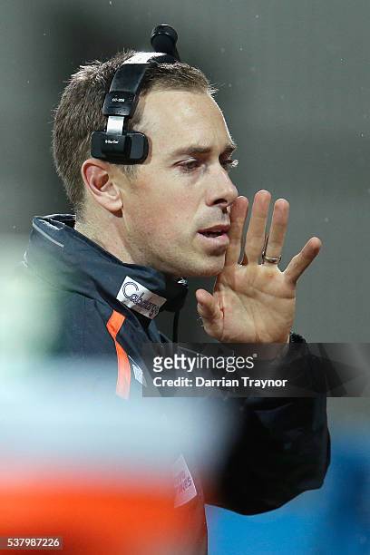 Former Collingwood captain Nick Maxwell gives instructions from the Giants bench during the round 11 AFL match between the Geelong Cats and the...