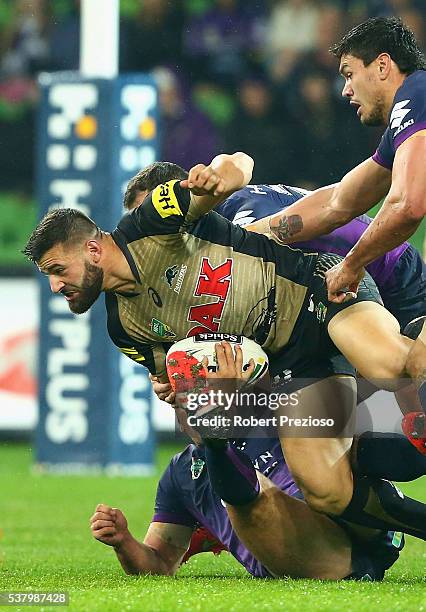 Josh Mansour of the Panthers is tackled during the round 13 NRL match between the Melbourne Storm and the Penrith Panthers at AAMI Park on June 4,...