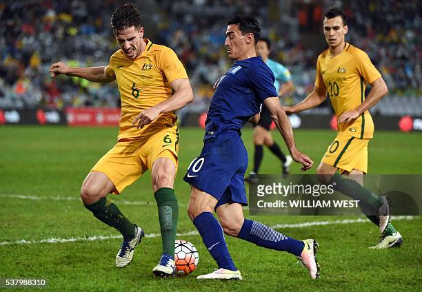 Australia's Milos Degenek tackles Lazaros Christodoulopoulos of Greece in their international football friendly match played in Sydney on June 4,...