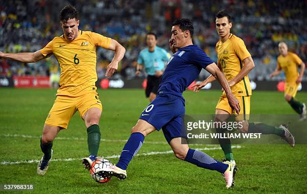 Australia's Milos Degenek tackles Lazaros Christodoulopoulos of Greece in their international football friendly match played in Sydney on June 4,...