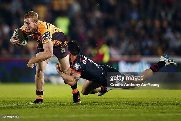 Jack Reed of the Broncos is tackled by Shaun Johnson of the Warriors during the round 13 NRL match between the New Zealand Warriors and the Brisbane...
