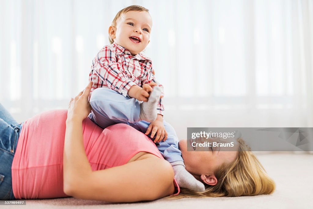 Pregnant mother and son having fun.