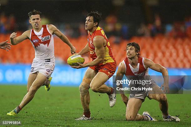 Jesse Lonergan of the Suns handballs during the round 11 AFL match between the Gold Coast Suns and the Sydney Swans at Metricon Stadium on June 4,...