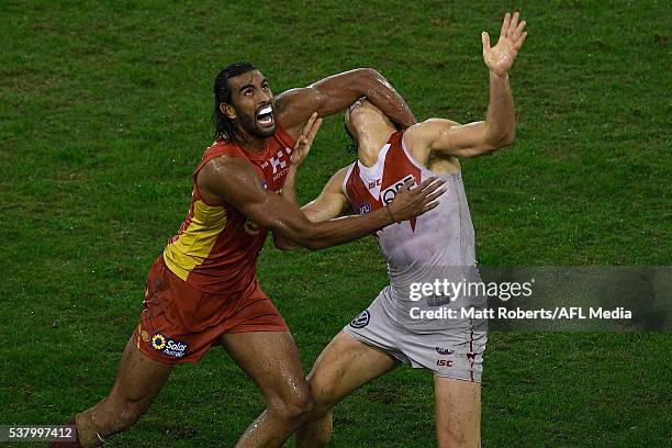 Tom Nicholls of the Suns competes for the ball against Kurt Tippett of the Swans during the round 11 AFL match between the Gold Coast Suns and the...