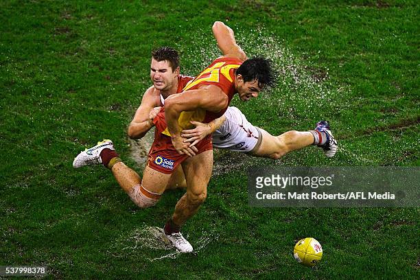 Jesse Lonergan of the Suns competes for the ball against Harrison Marsh of the Swans during the round 11 AFL match between the Gold Coast Suns and...