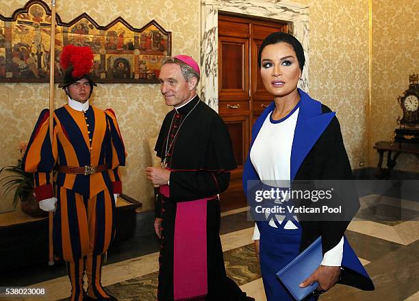 Sheikha Mozah bint Nasser Al Missned, flanked by Prefect of the Pontifical House Georg Ganswein, arrives at the Apostolic Palace for a meeting with...