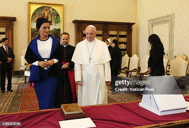 Pope Francis exchanges gifts with Sheikha Mozah bint Nasser Al Missned at his private library in the Apostolic Palace on June 4, 2016 in Vatican...