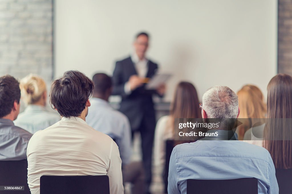 Business people attending a seminar.