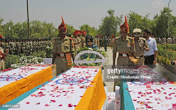 Chief Minister of Jammu and Kashmir Mehbooba Mufti lays a wreath on the coffins of three paramilitary soldiers during a wreath laying ceremony on the...