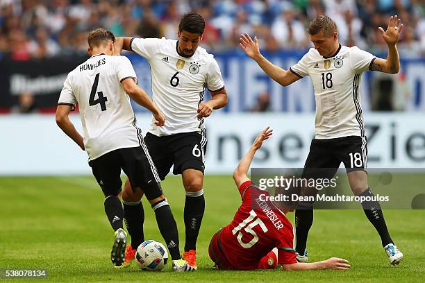 Benedikt Howedes, Sami Khedira and Toni Kroos of Germany battles for the ball with Laszlo Kleinheisler of Hungary during the international friendly...