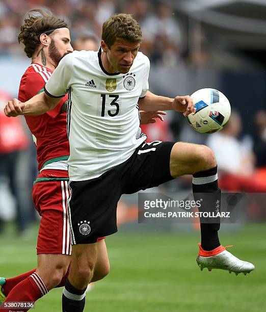 Germany's midfielder Thomas Mueller and Hungary´s Tamas Kadarr vie for the ball during the UEFA EURO 2016 friendly football match Germany vs Hungary...
