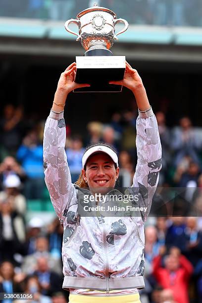 Garbine Muguruza of Spain poses with the trophy following her victory during the Ladies Singles final match against Serena Williams of the United...
