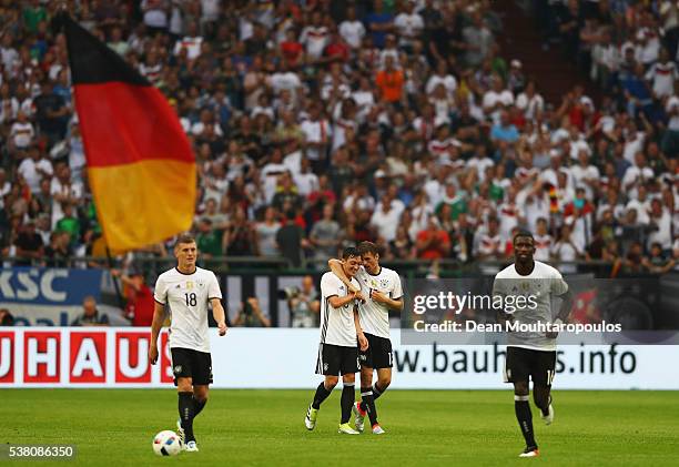 Thomas Muller of Germany celebrates scoring his teams second goal of the game with Mesut Ozil during the international friendly match between Germany...