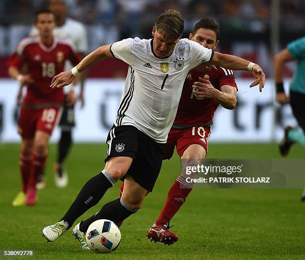 Germany's midfielder Bastian Schweinsteiger and Hungary´s Zoltan Gera vie during the UEFA EURO 2016 friendly football match Germany vs Hungary at the...