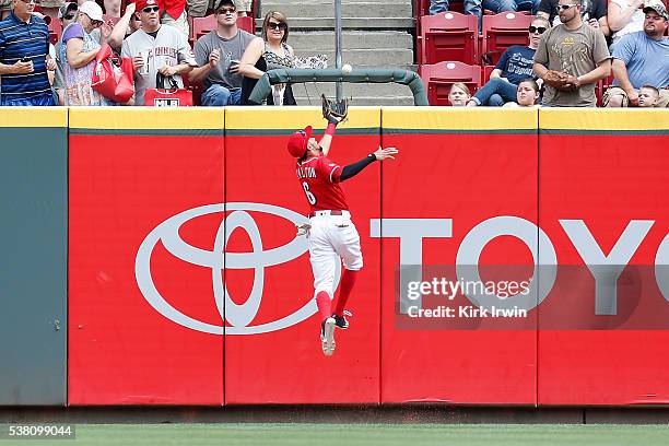 Billy Hamilton of the Cincinnati Reds makes a jumping catch to force out Ben Revere of the Washington Nationals during the first inning at Great...