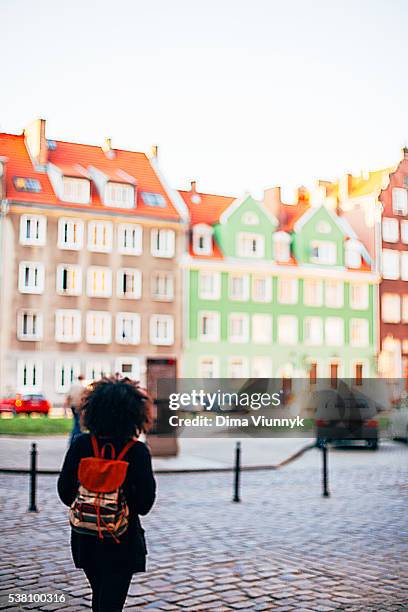 woman walking on the street - gdansk stock pictures, royalty-free photos & images