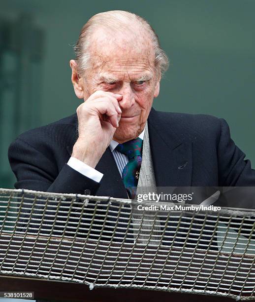 Prince Philip, Duke of Edinburgh watches the racing from the balcony of the Royal Box as he attends Derby Day during the Investec Derby Festival at...