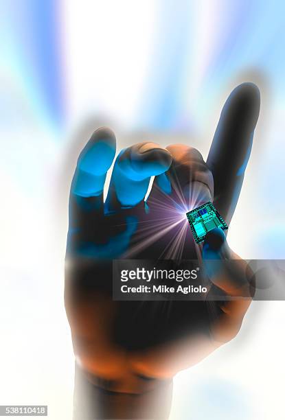 hand holding computer chip - mike agliolo stockfoto's en -beelden