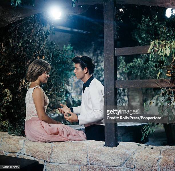 British singer and actor, Cliff Richard and American singer and actress, Lauri Peters pictured together in a scene from the film Summer Holiday at...