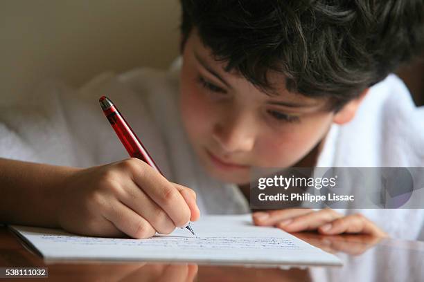 boy writing a letter - pen writing foto e immagini stock