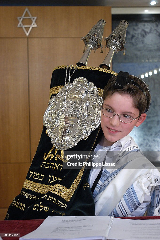 Boy at Bar Mitzvah with Torah Scrolls