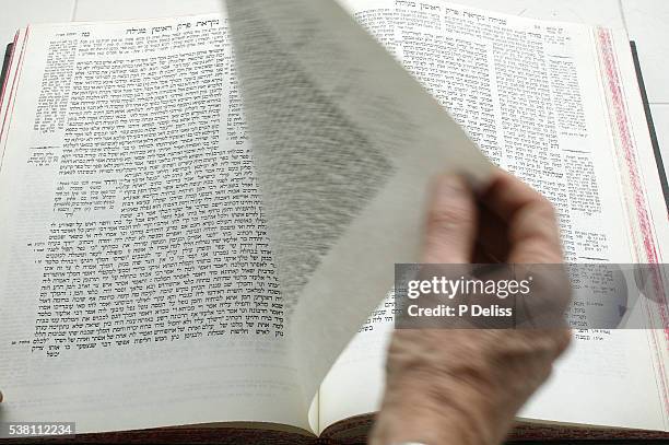 hand turning page of talmud - hand turning page stock pictures, royalty-free photos & images