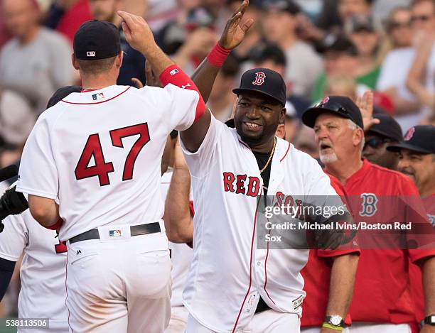 David Ortiz of the Boston Red Sox celebrates with Travis Shaw after a 4-6 win over the Toronto Blue Jays on June 4, 2016 at Fenway Park in Boston,...