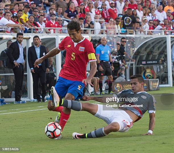 Celso Borges of Costa Rica is tackled by Derlis Gonzalez of Paraguay at the group A match between Costa Rica and Paraguay at Camping World Stadium as...