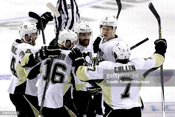 Ben Lovejoy of the Pittsburgh Penguins celebrates with his teammates after scoring during the first period against the San Jose Sharks in Game Three...
